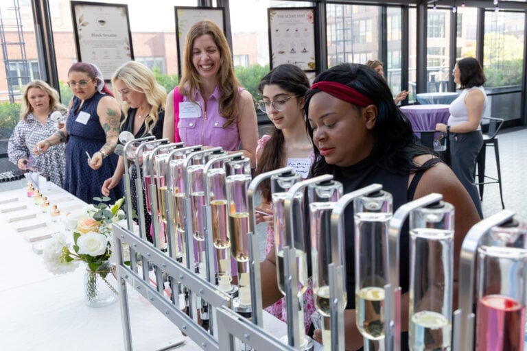 Bridal shower guests at a Glitters & Grace perfume bar