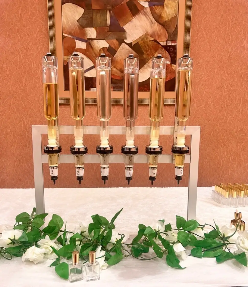Gold dispenser tower with a greenery garland, an idea for an Arab wedding reception
