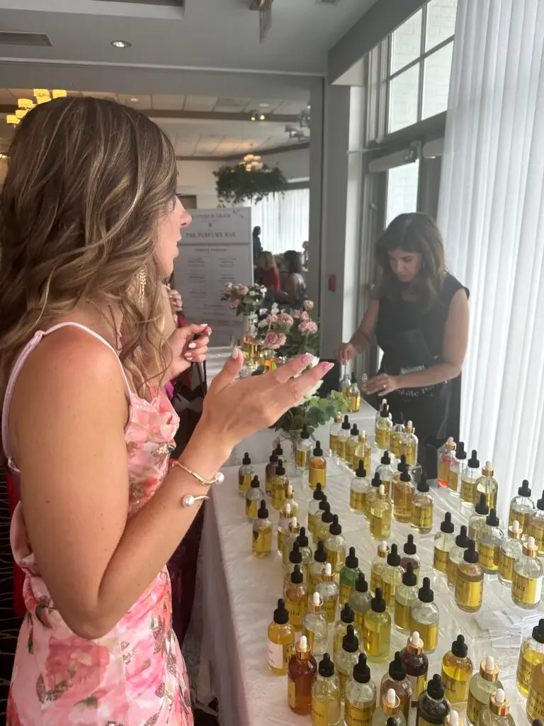 Bridal shower guests at a Glitters & Grace perfume bar