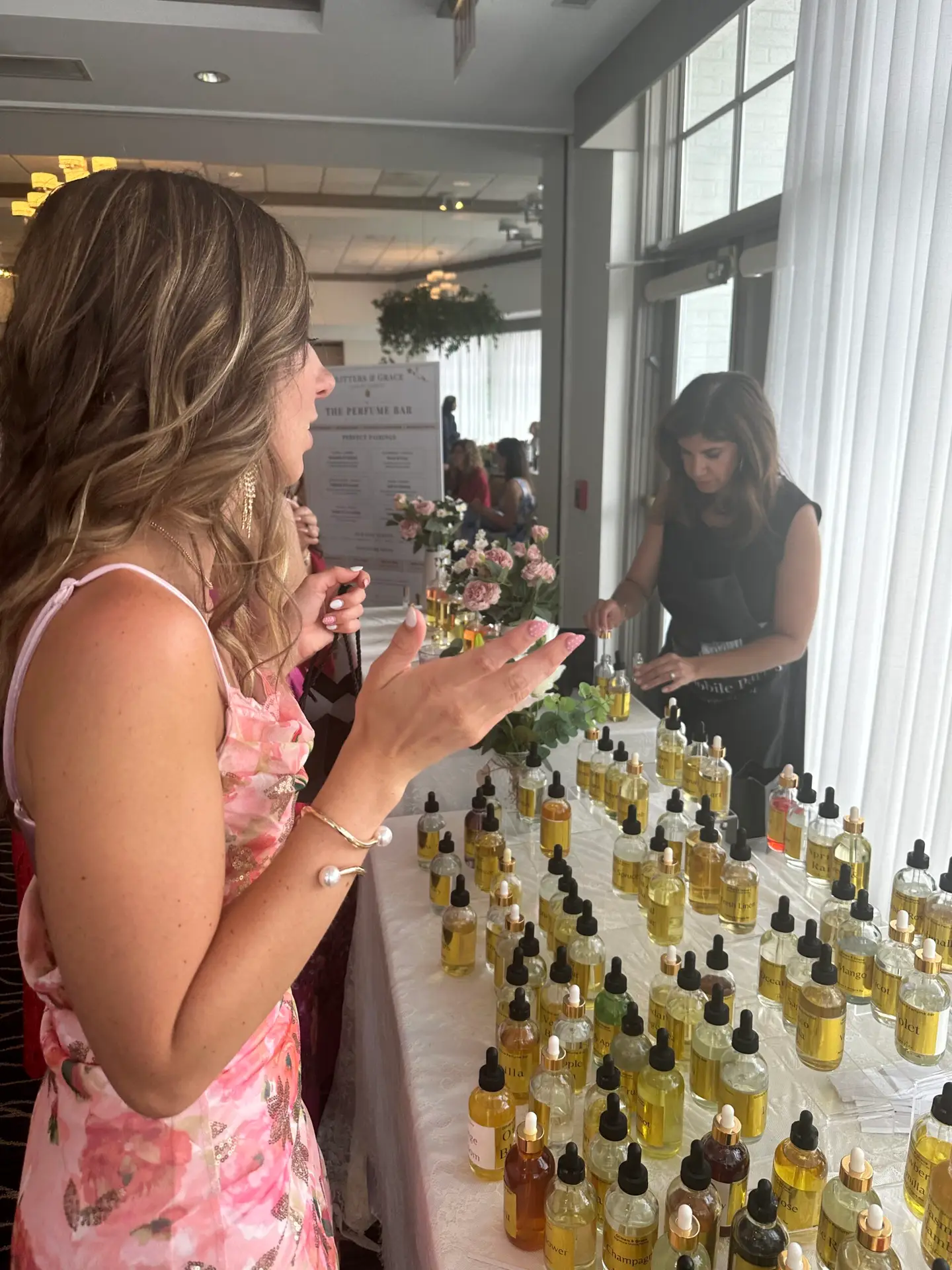 Guests blending their own fragrances at a Glitters and Grace mobile perfume bar at a private event