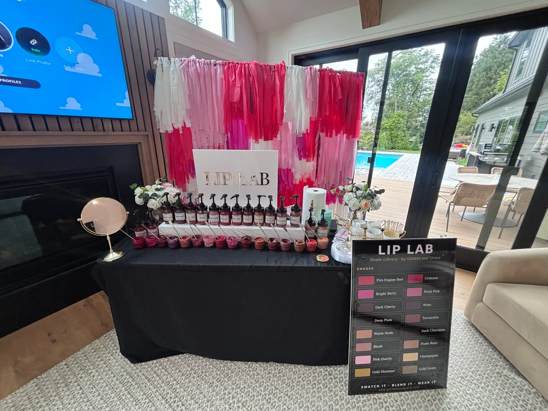 Lip Lab with a pink and red fringe backdrop
