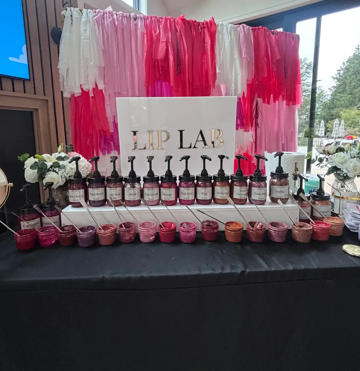 Lip Lab bar with a pink and red fringe backdrop