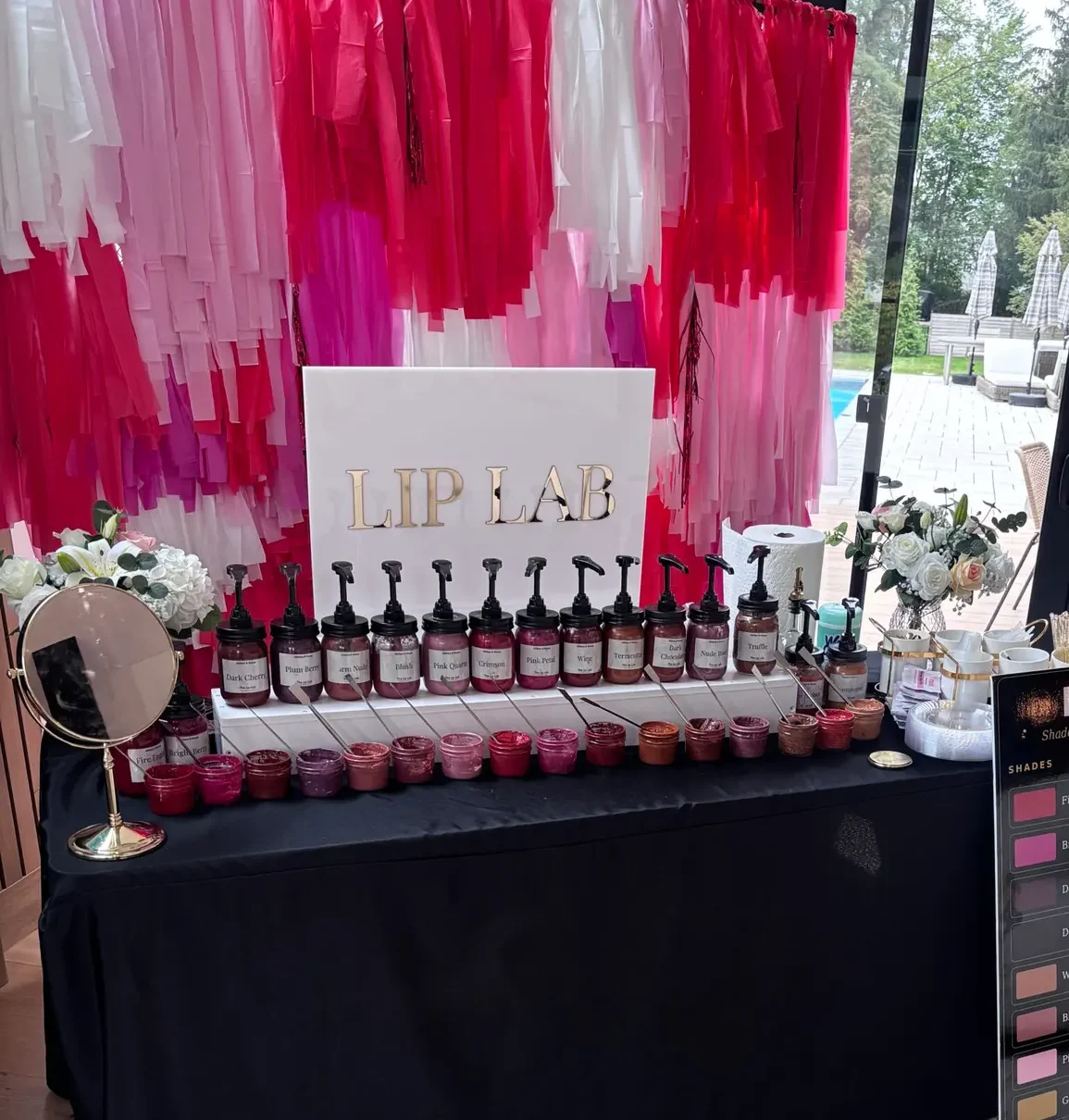 Lip Lab with a fringe backdrop by a pool house