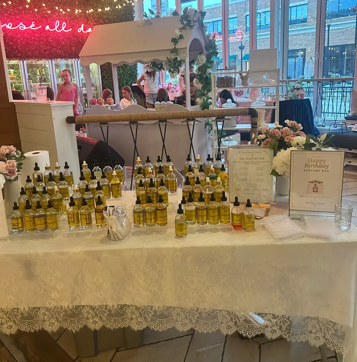 The kid-friendly scent library at a Glitters and Grace Mini Perfume Bar, arranged by family