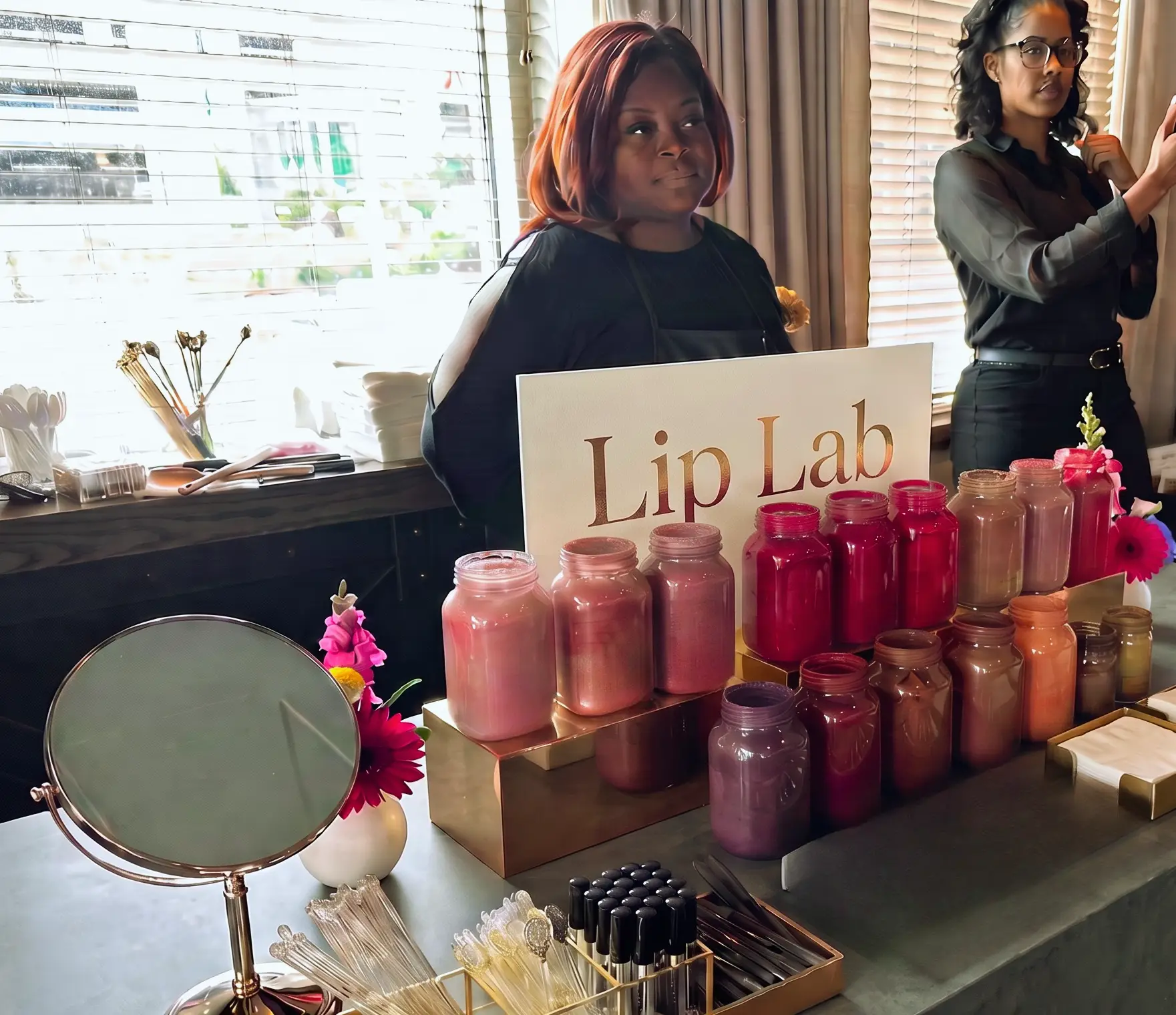 Host guiding guests at a mobile lip gloss bar
